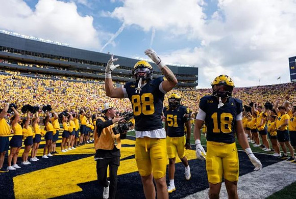 Deakon Tonielli (88), McHale Blade (51), Troy Bowles (18), and Michigan Cheerleaders