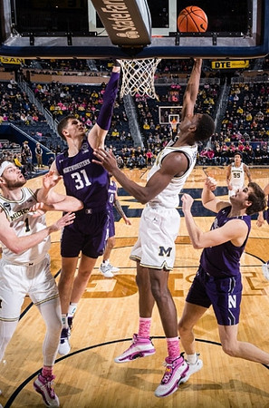 Hunter Dickinson (1), Moussa Diabate (14), and Eli Brooks (55)