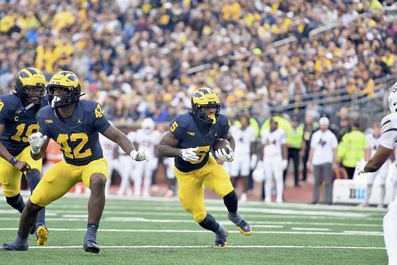 Bryce Underwood (19), Jalen Hoffman (42), and Savion Hiter (5)