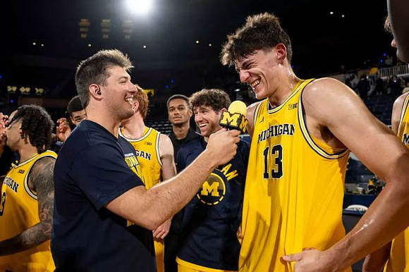 J.P. Estrella (13) and Michigan Team