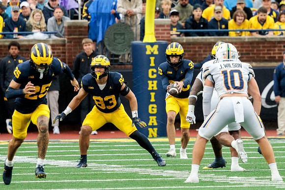 Mason Curtis (25), Zack Marshall (83), and Cam Brown (33)