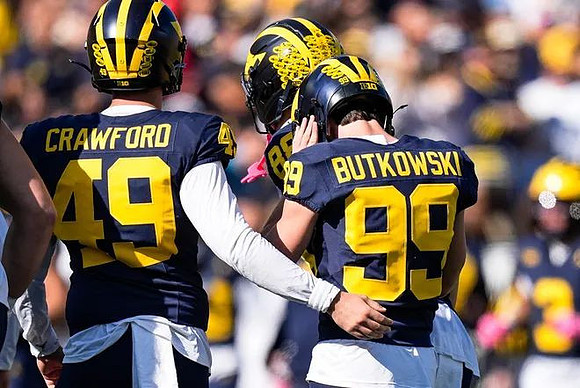 Nico Crawford (49) and Trey Butkowski (99)