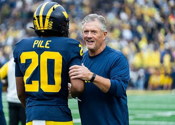 Jaylen Pile (20) and Kyle Whittingham