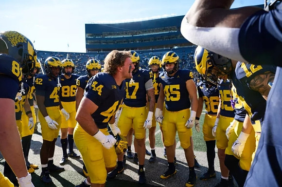 Max Bredeson (44) and Michigan Team