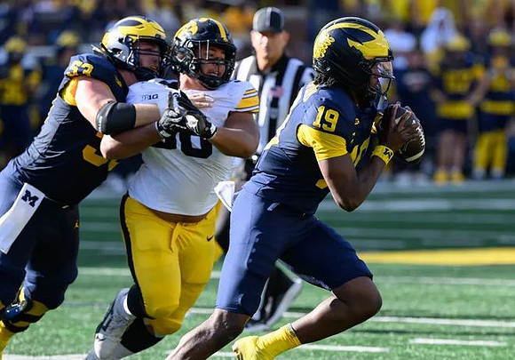 Jake Guarnera (53) and Bryce Underwood (19)