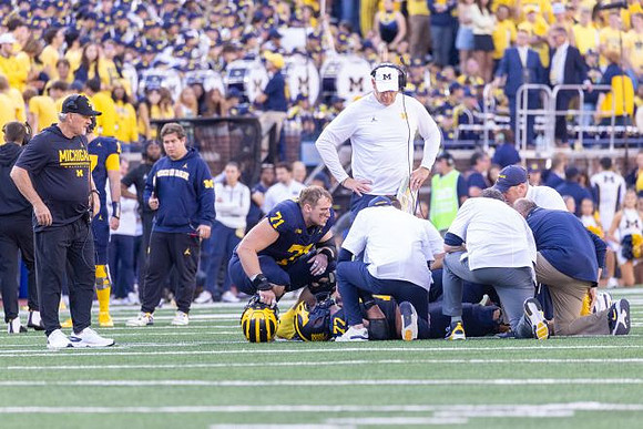 Evan Link (71), Blake Frazier (77), Jay Hill, and Kyle Whittingham
