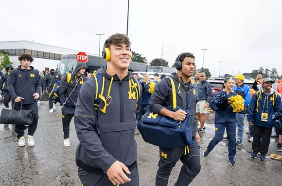 Zack Marshall (83), Jordan Marshall (23), and Michigan Team