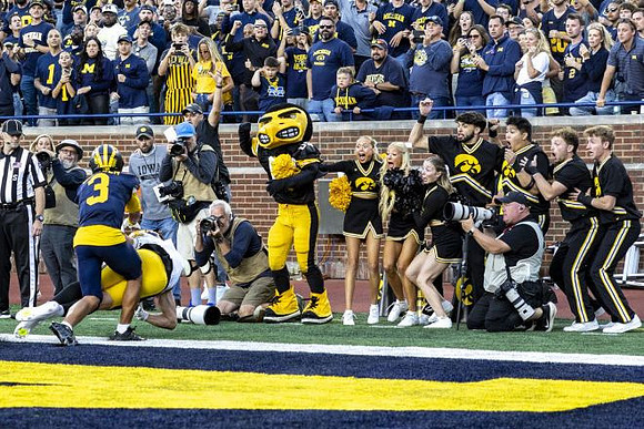 Andrew Marsh (3) and Iowa Mascot
