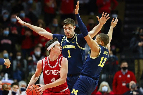 Hunter Dickinson (1) and DeVante' Jones (12)