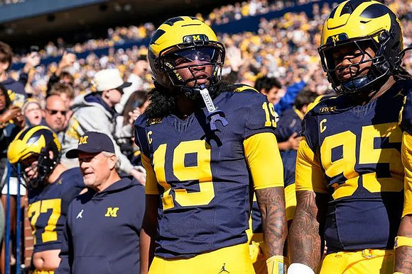 Kyle Whittingham, Bryce Underwood (19), and Michigan Team