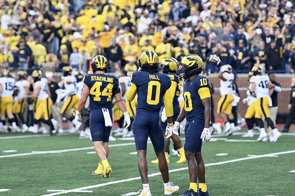 Nathaniel Staehling (44), Jyaire Hill (0), and Zeke Berry (10)