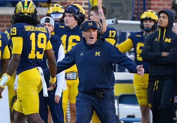 Jaime Ffrench (10), Kyle Whittingham, and Michigan Team