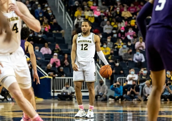 Jaron Faulds (44) and DeVante' Jones (12)