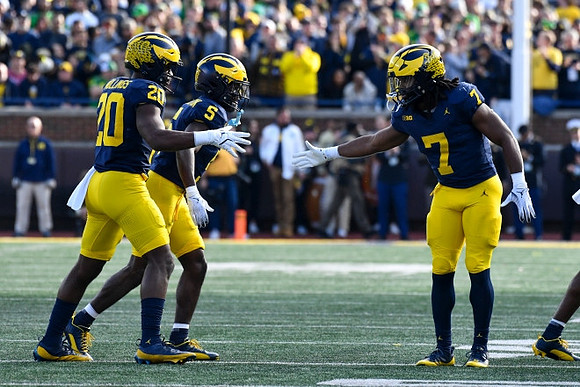 Kalel Mullings (20), C.J. Charleston (5), and Donovan Edwards (7)