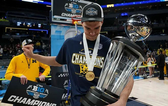 Vladislav Goldin (50) and Big Ten Tournament Championship Trophy