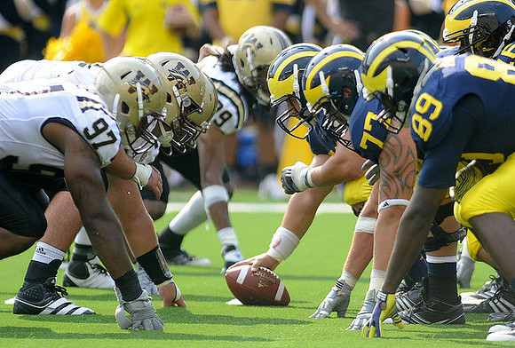 David Molk (50), Taylor Lewan (77), Brandon Moore (89), and Denard Robinson (16)