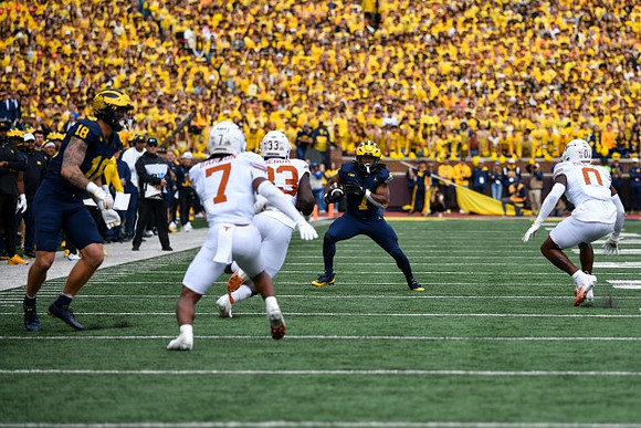 Colston Loveland (18) and Donovan Edwards (7)