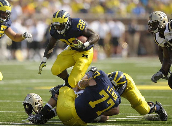 Fitzgerald Toussaint (28) and Taylor Lewan (77)