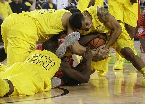 Jordan Morgan (52), Caris LeVert (23), and Trey Burke (3)