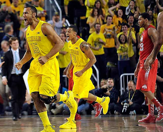 Jon Horford (15) and Trey Burke (3)