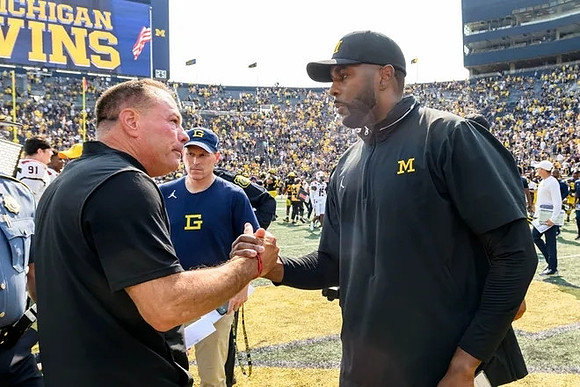 Arkanas State Head Coach Butch Jones and Sherrone Moore