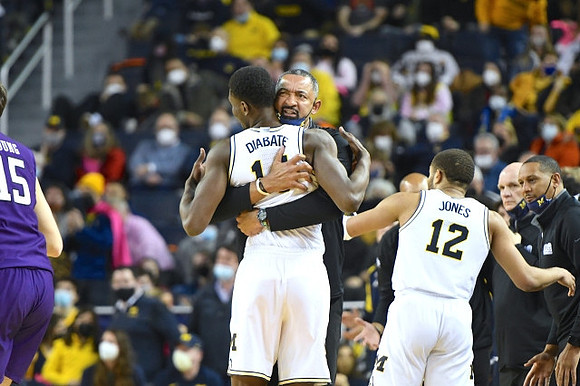 Moussa Diabate (14), Juwan Howard, DeVante' Jones (12), Howard Eisley, and Phil Martelli