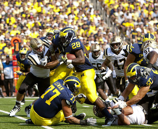 Kevin Koger (86), Taylor Lewan (77), Fitzgerald Toussaint (28), Patrick Omameh (65), and David Molk (50)