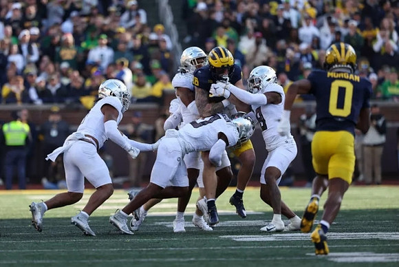 Colston Loveland (18) and Semaj Morgan (0)