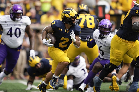 Blake Corum (2) and Myles Hinton (78)
