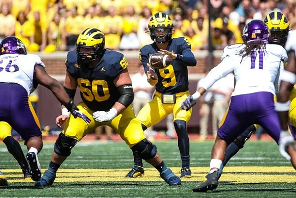 Drake Nugent (60) and J.J. McCarthy (9)