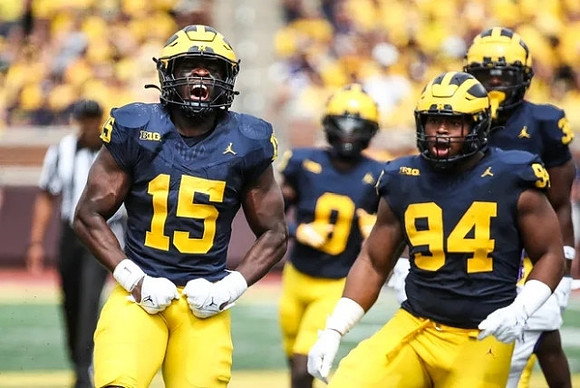 Ernest Hausmann (15), Mike Sainristil (0), Kris Jenkins (94), and Jaylen Harrell (32)