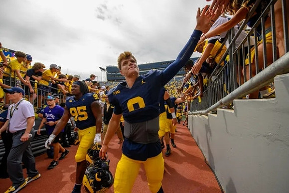 Trey Pierce (95) and J.J. McCarthy (9)