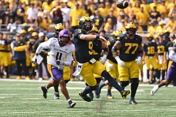J.J. McCarthy (9) and Trevor Keegan (77)