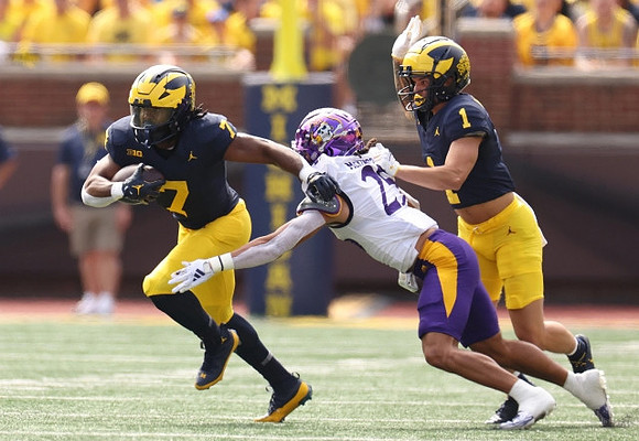 Donovan Edwards (7) and Roman Wilson (1)