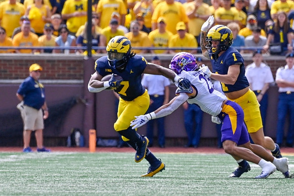 Donovan Edwards (7) and Roman Wilson (1)
