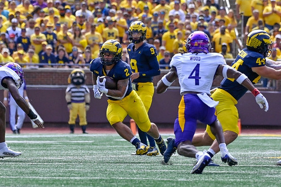 Blake Corum (2), J.J. McCarthy (9), and Max Bredeson (44)