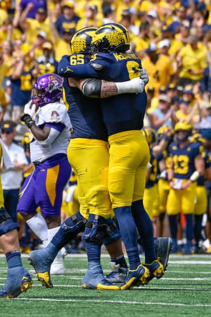 Zak Zinter (65) and J.J. McCarthy (9)
