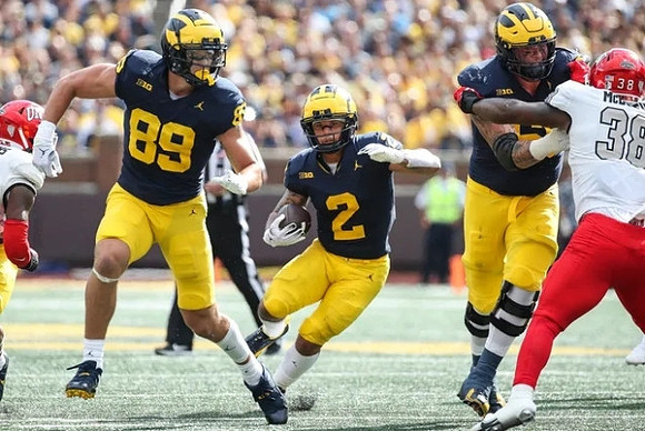 AJ Barner (89), Blake Corum (2), and Zak Zinter (65)