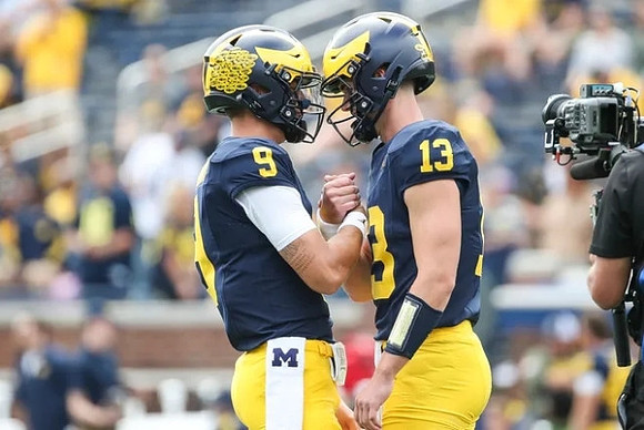 J.J. McCarthy (9) and Jack Tuttle (13)
