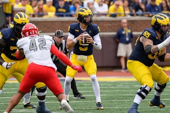 Myles Hinton (78), J.J. McCarthy (9), and Zak Zinter (65)