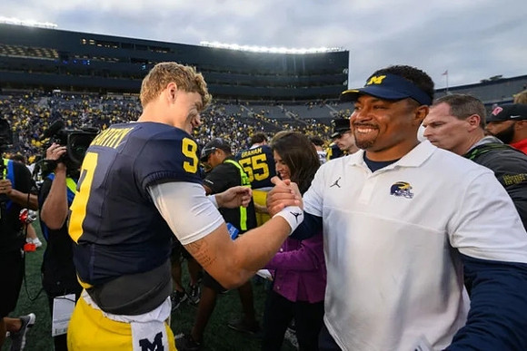 J.J. McCarthy (9) and Mike Hart