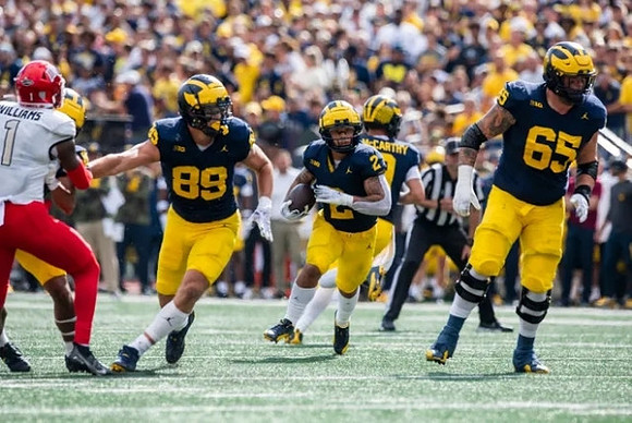 AJ Barner (89), Blake Corum (2), J.J. McCarthy (9), and Zak Zinter (65)