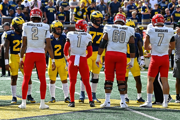 Michael Barrett (23), Blake Corum (2), Trevor Keegan (77), and Mike Sainristil (0)