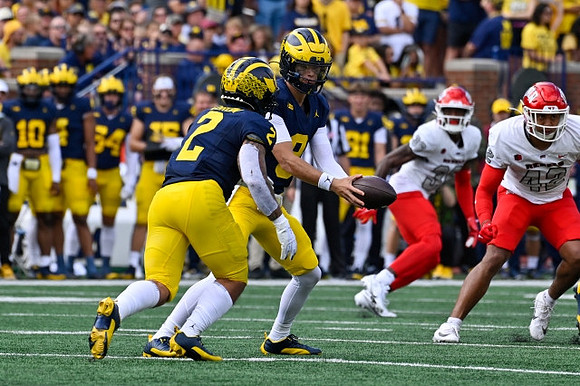 Blake Corum (2) and J.J. McCarthy (9)