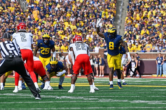 Junior Colson (25), Kris Jenkins (94), and Derrick Moore (8)
