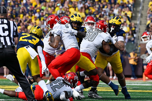Michael Barrett (23), Jaylen Harrell (32), and Mason Graham (55)