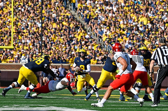 Myles Hinton (78), J.J. McCarthy (9), and Zak Zinter (65)