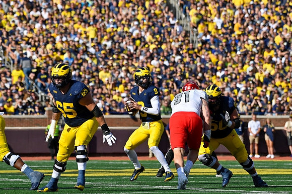Zak Zinter (65), J.J. McCarthy (9), and Drake Nugent (60)
