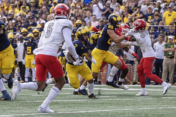 Blake Corum (2), Colston Loveland (18), and AJ Barner (89)