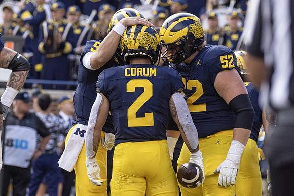 J.J. McCarthy (9), Blake Corum (2), and Karsen Barnhart (52)
